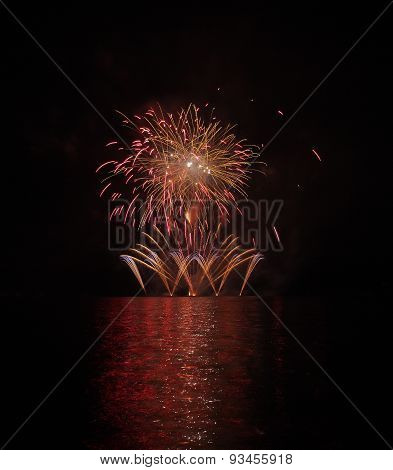 Colorful Fireworks With Reflection On Lake.