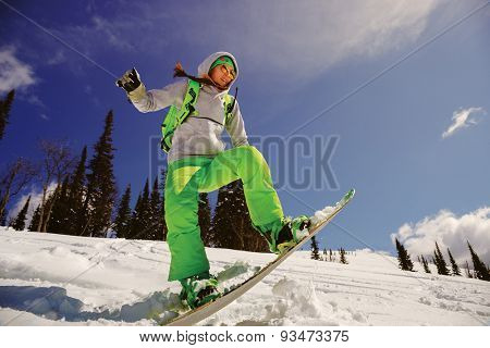 Snowboarder jumping through air with deep blue sky in background