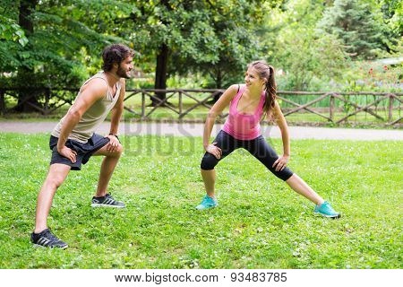 Couple doing stretching outdoors