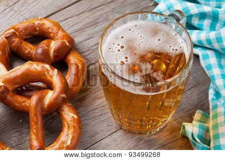 Beer mug and pretzel on wooden table