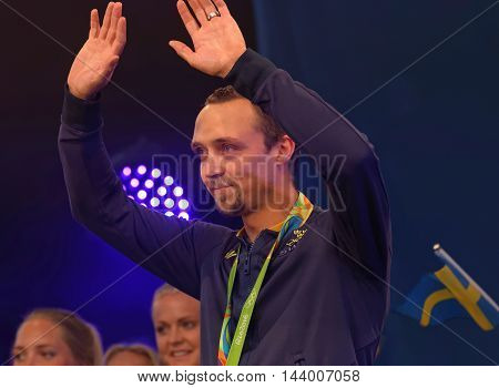 STOCKHOLM SWEDEN - AUG 21 2016: Happy swedish male skeet shooter Marcus Svensson when swedish olympic athletes are celebrated in Kungstradgarden StockholmSwedenAugust 212016