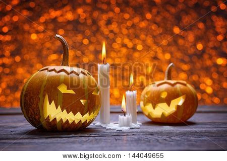 Pumpkin for Halloween, lamp pumpkin, antique wood, celebrating halloween, smiley on a pumpkin, paraffin candles, bright background, burning candles