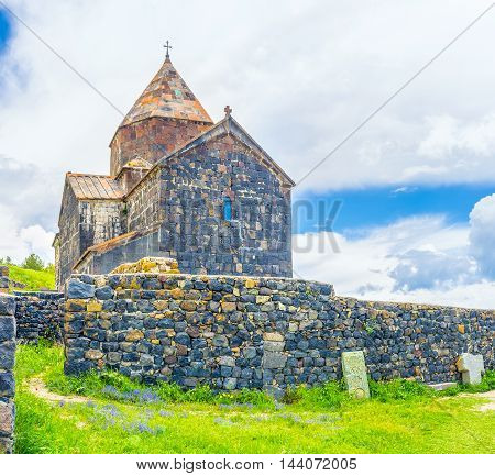The massive stone fence in front of Surp Arakelots (Holy Apostles) Church of Sevanavank Monastery Sevan Armenia.