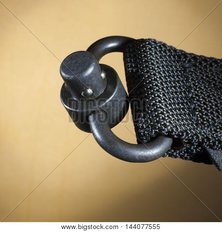 Rig used to attach a nylon sling fast on a tan background