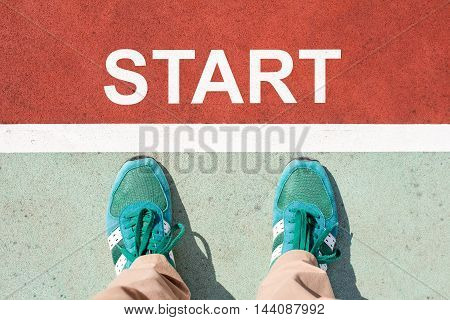Top view of foot on the trail with the word START for the concept of starting point