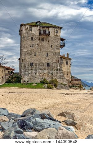 Beach and Medieval tower in  Ouranopoli, Athos, Chalkidiki, Central Macedonia, Greece