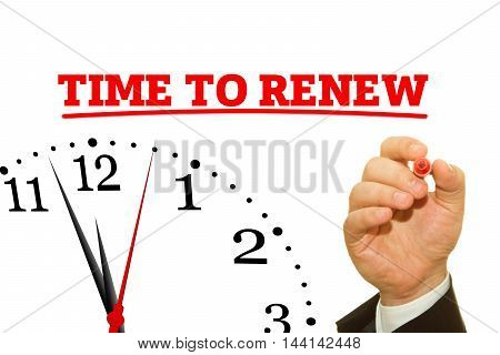 Businessman hand writing TIME TO RENEW message on a transparent wipe board.