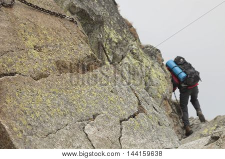 Poland Tatra Mountains Climber at Orla Perc Route (background) via ferrata chains foreground