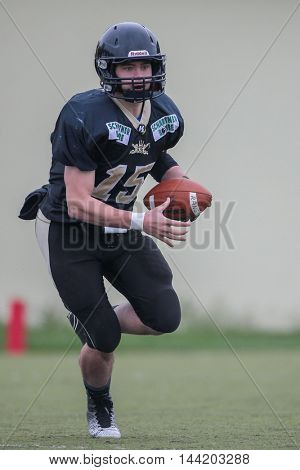 MOEDLING, AUSTRIA - MAY 24, 2015: QB Benjamin Braeuer (#15 Rangers) runs with the ball in a game of the Division I of the Austrian Football League.