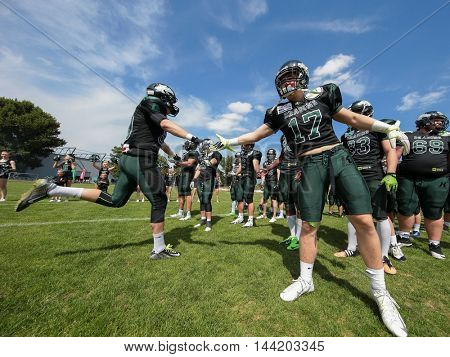 VIENNA, AUSTRIA - MAY 31, 2015:CB Maximilian Zangl (#17 Dragons) welcomes WR Philipp Haun (#80 Dragons) on the field before a game of the Austrian Football League.