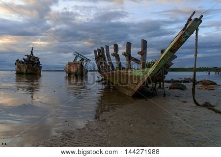 some dilapidated fishing boats were left stranded at the mouth of river sand spread Sitompok Kuala Penyu Sabah.