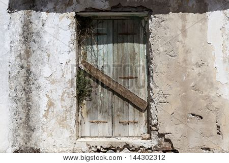 Old door in the stone walls of the village houses. Excellent background