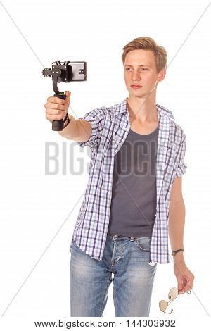 Man Holds Small Action Camera On Gimbal.