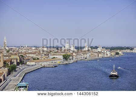 A panoramic view of Venice with a tugboat in the foregound Venice Italy