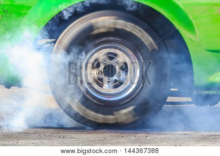 Drag Racing Car Burns Rubber Off Its Tires In Preparation For The Race