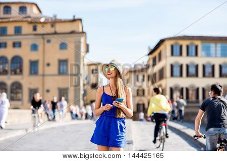 Young female traveler using mobile phone during the weekend in Florence