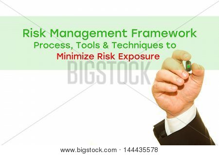 Businessman hand writing Risk Management Framework. Process, Tools & Techniques to Minimize Risk Exposure. Risk Management concept.