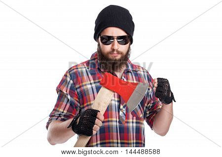 Confident young bearded man holding an axe and looking at camera while standing against white background