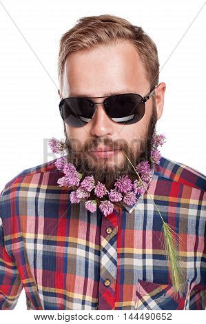 Portrait of handsome man with beard of clover flowers isolated on white