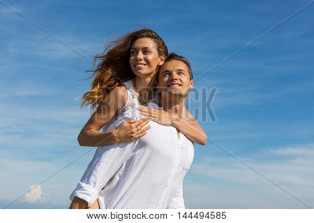 happy couple in love walking on the beach in summer white dress