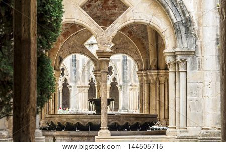 Detail of the cloister of Santa Maria de Poblet Monastery, Unesco heritage. Romanesque cloister architecture in Poblet, Spain.