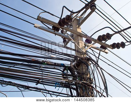 Tangled haywire Electric cable on Concrete Pole