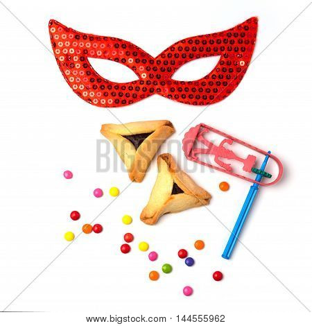 Hamantaschen cookies grogger and carnival mask on white background