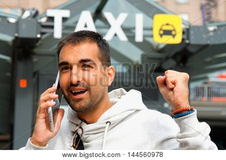 Man feeling lacky in order a taxi from his cell phone
