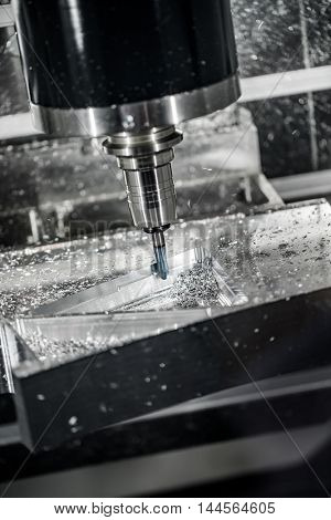 Metalworking CNC milling machine. Cutting metal modern processing technology. Small depth of field. Warning - authentic shooting in challenging conditions. A little bit grain and maybe blurred.