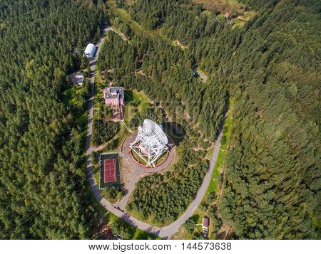 Aerial view radio telescope in forest at countryside in saint-Petersburg Russia