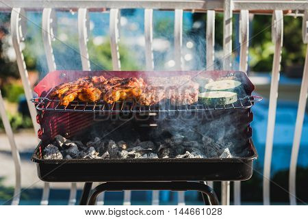 Delicious Meat On Barbecue Grill With Coal On Balcony.