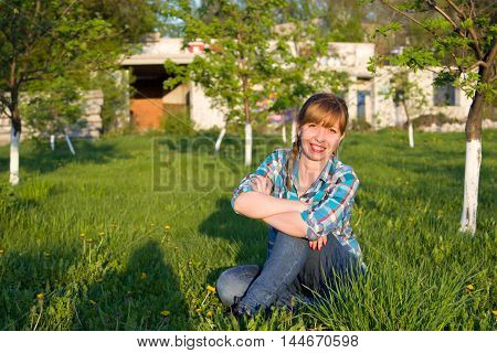 Portrait of a girl in a park on the grass