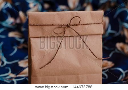 Kraft bag for gifts. Package products. Package for lunch tied with rope brown