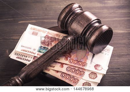 Gavel and some ruble banknotes.Auction bidding, judicial system corruption concept.Toned