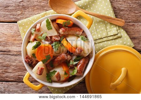 Tasty Irish Coddle With Pork Sausages, Bacon And Vegetables In A Yellow Pot. Horizontal Top View