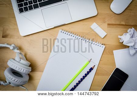 desk, computer, paper, phone on a wooden table