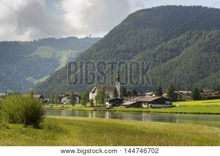 Sankt Ulrich Am Pillersee With Jakobskreuz On The Buchensteinwand Summit