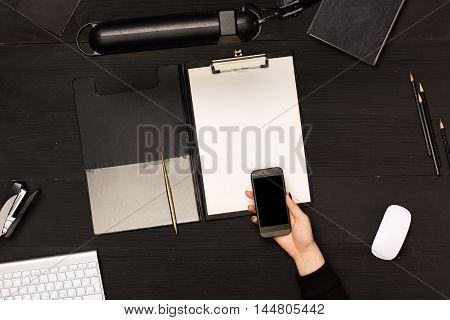 Office wooden desk table with computer, supplies and coffee cup. Top view with copy space. All in black color. photos for posts, blogs, advertising and news