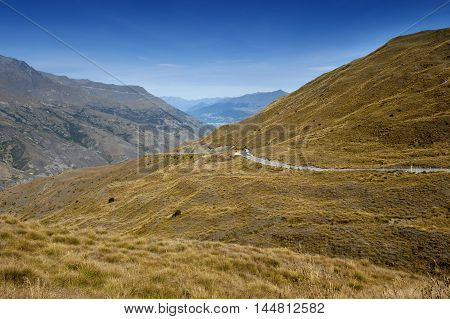 Scenic Viewpoint Of Road, Mountains, And Lake In South Island Of New Zealand