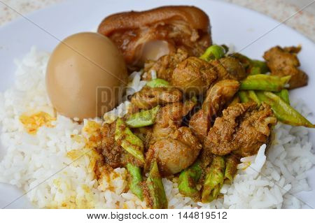 spicy stir fried curry chicken entrails and sweet boiled brown egg on rice