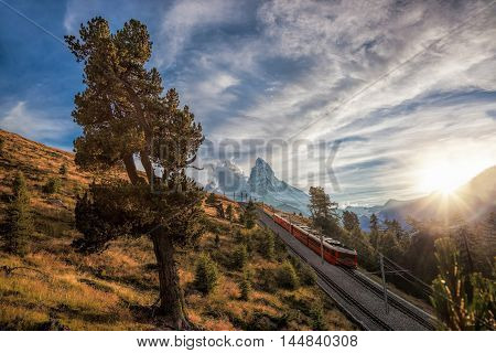 Matterhorn Peak With A Train Against Sunset In Swiss Alps, Switzerland