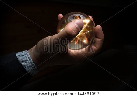 Holding atom in fortune teller magic crystal ball