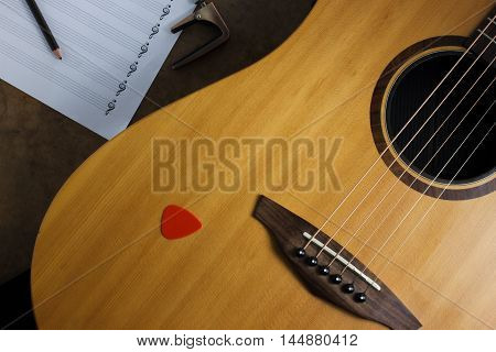 still life photography concept by acoustic guitar