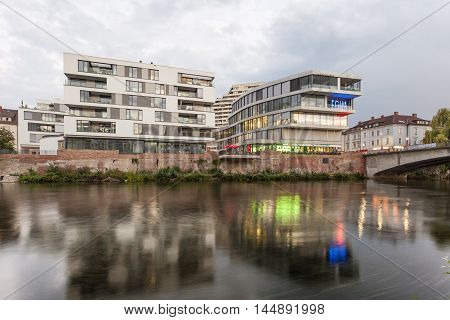 ULM GERMANY - AUG 17 2016: Modern buildings reflection in the Danube river in the city of Ulm Germany