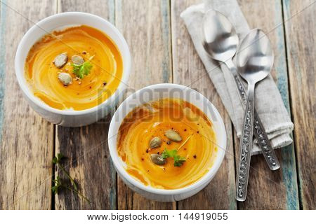 Fresh carrot and pumpkin  soup in white bowl. Dietary vegetable and healthy food.