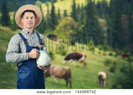 Milkman with glass jar on blurred mountain meadow background