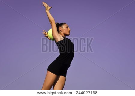 Gymnastics For You. Woman Gymnast In Black Sportswear With Green Ball. Sport And Success. Flexibilit