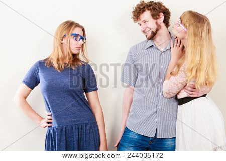 Jealousy And Betrayal Concept. Abandoned Jelous Girl Watching On Happy Couple - Young Attractive Blo