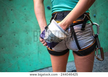 The Climber Is Preparing To Climb The Route. The Woman Rubs Her Hands With Magnesium. Preparation Fo