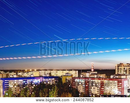 Star Tracks Over Odintsovo Town, Moscow Region, Russia. Long Exposure Of Starry Night Sky.